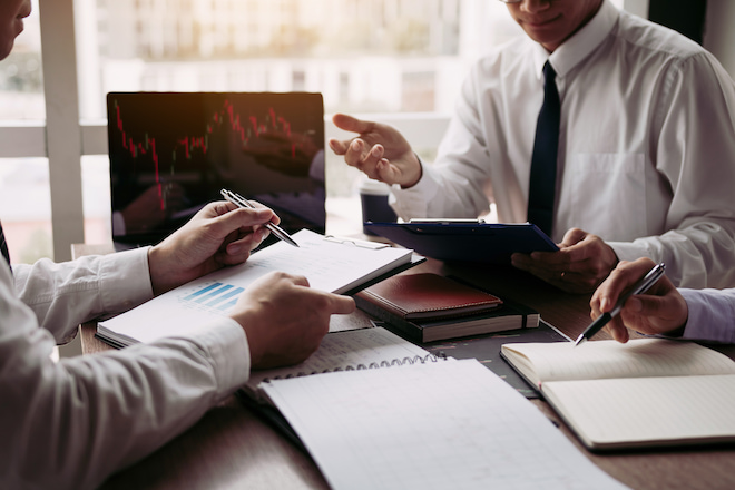 broker speaking to a client in his office